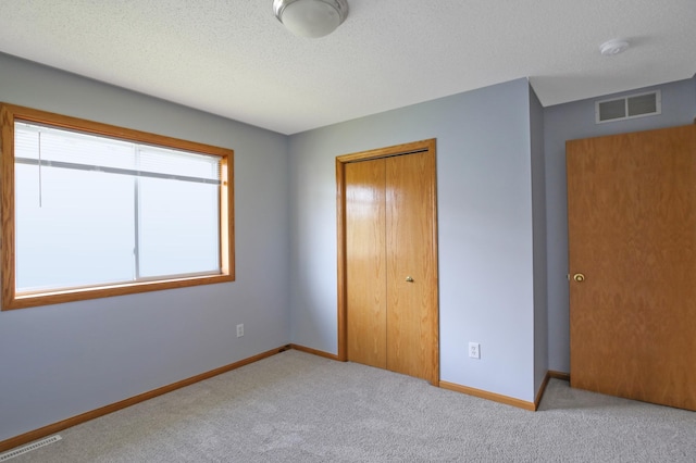 304 Tanager Path, Mankato, MN 56001 - unfurnished bedroom featuring carpet floors, a closet, and a textured ceiling