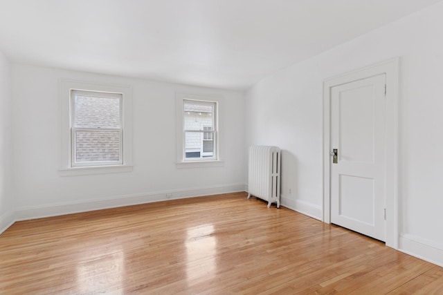 720 40th St, Minneapolis, MN 55409 - spare room featuring radiator heating unit and light wood finished floors
