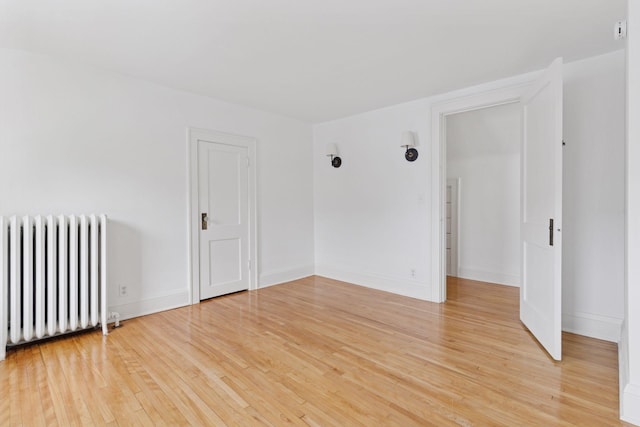 720 40th St, Minneapolis, MN 55409 - spare room featuring radiator and light wood-type flooring