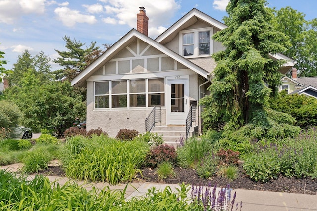 720 40th St, Minneapolis, MN 55409 - tudor-style house featuring stucco siding, a chimney, and entry steps