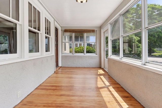 720 40th St, Minneapolis, MN 55409 - unfurnished sunroom featuring a textured wall and wood finished floors