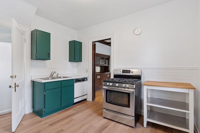 720 40th St, Minneapolis, MN 55409 - kitchen with gas stove, dishwasher, green cabinets, light countertops, and light wood-style floors