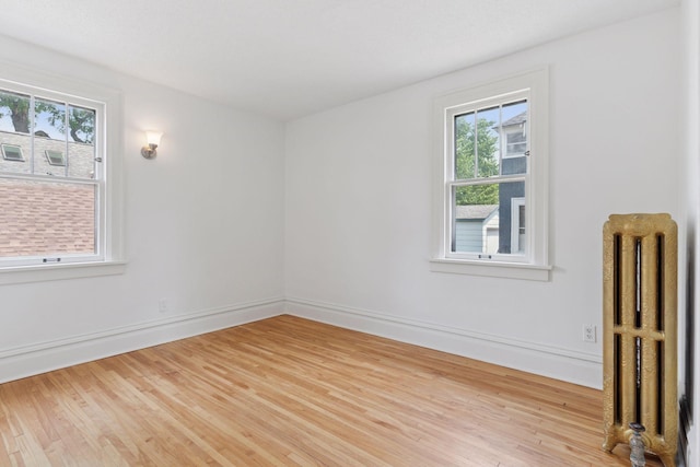 720 40th St, Minneapolis, MN 55409 - spare room featuring radiator and wood finished floors