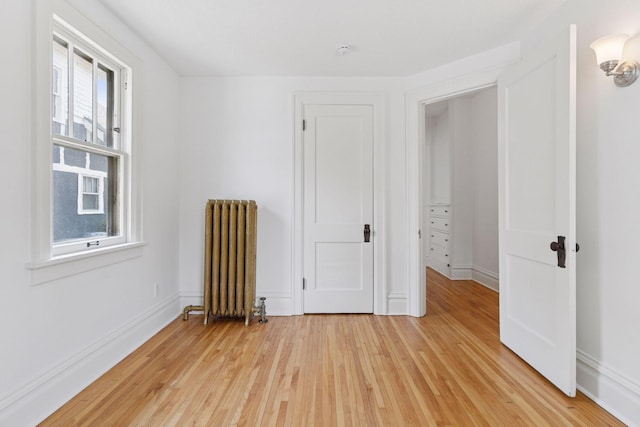 720 40th St, Minneapolis, MN 55409 - empty room with radiator and light wood finished floors