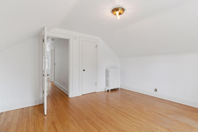 720 40th St, Minneapolis, MN 55409 - additional living space featuring radiator, light wood-style floors, and lofted ceiling