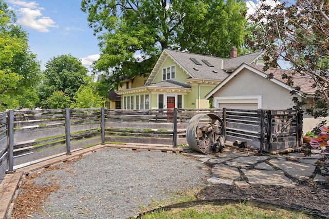 720 40th St, Minneapolis, MN 55409 - view of front of home with a shingled roof, an attached garage, a chimney, stucco siding, and a gate