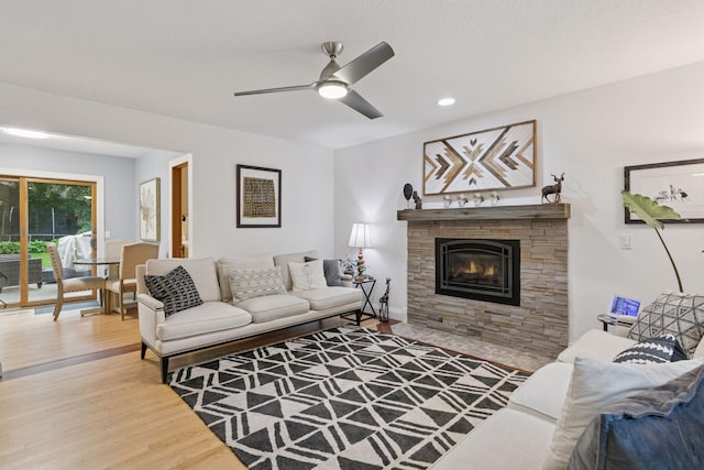 17233 Harrington Way, Lakeville, MN 55044 - living area featuring wood finished floors, a stone fireplace, ceiling fan, and recessed lighting