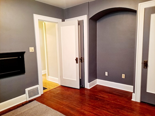 4223 12th Ave S, Minneapolis, MN 55407 - empty room with wood finished floors and arched walkways