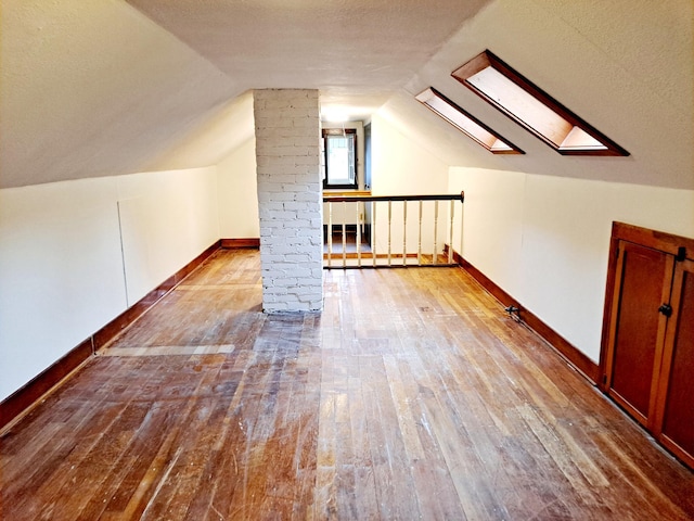 4223 12th Ave S, Minneapolis, MN 55407 - additional living space with hardwood / wood-style floors, lofted ceiling, and a skylight