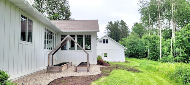 9029 Crown Hill Ct, Brainerd, MN 56401 - rear view of house with roof with shingles, a yard, and board and batten siding