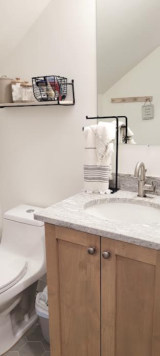 9029 Crown Hill Ct, Brainerd, MN 56401 - half bath featuring vanity, lofted ceiling, and tile patterned flooring