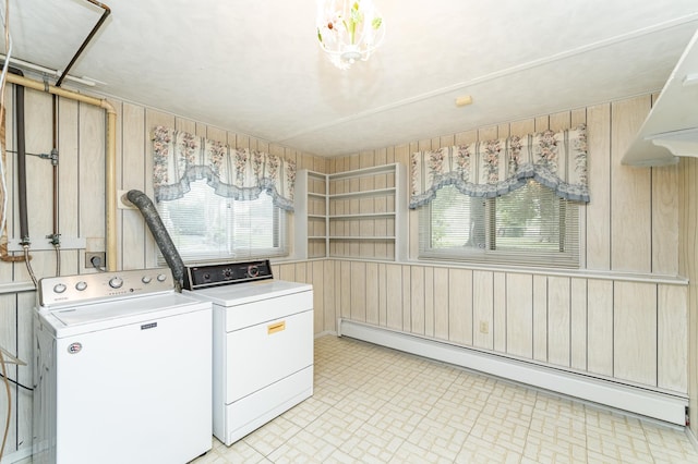 2407 27th Ave NW, Rochester, MN 55901 - laundry room with baseboard heating, washer and clothes dryer, and wood walls