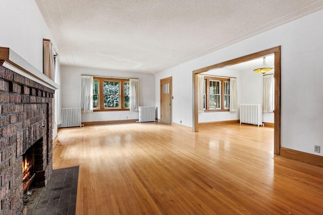 4300 Beard Ave S, Minneapolis, MN 55410 - unfurnished living room with radiator, wood finished floors, and a textured ceiling