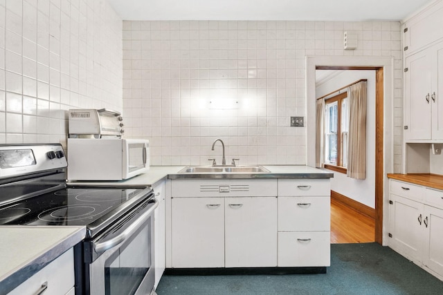 4300 Beard Ave S, Minneapolis, MN 55410 - kitchen featuring electric range, stainless steel countertops, white microwave, white cabinets, and tile walls