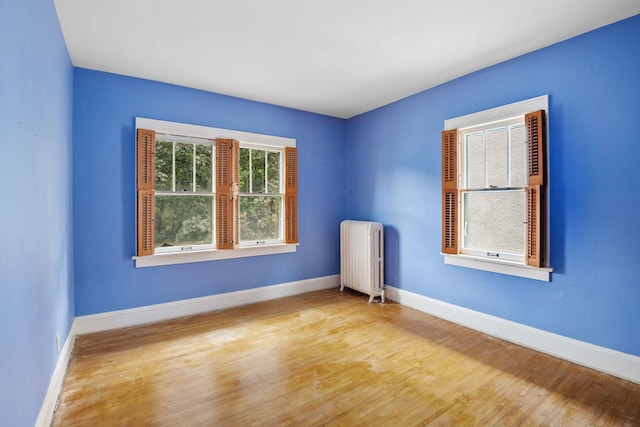 4300 Beard Ave S, Minneapolis, MN 55410 - empty room with radiator heating unit and wood finished floors