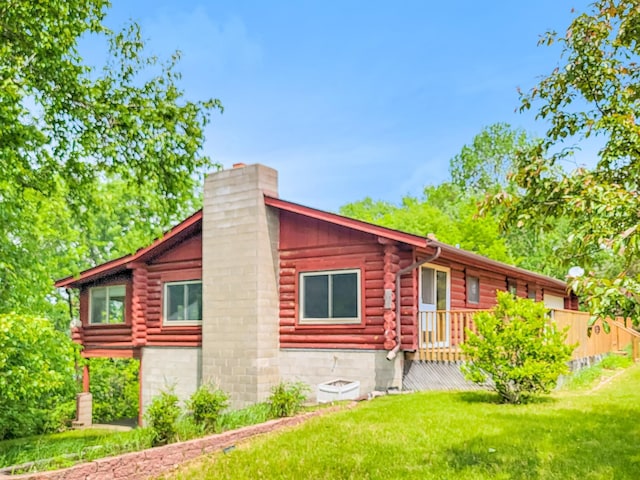 1283 Island Lake Dr NW, Powers Twp, MN 56435 - view of front of home with a chimney, log siding, and a front yard