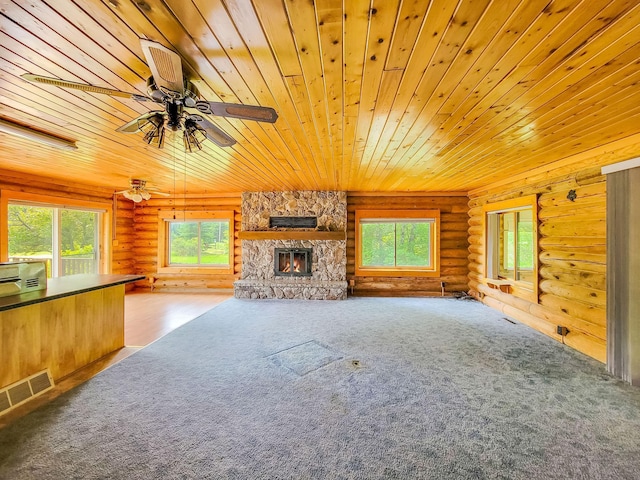 1283 Island Lake Dr NW, Powers Twp, MN 56435 - unfurnished living room featuring rustic walls, wood ceiling, a fireplace, carpet, and ceiling fan
