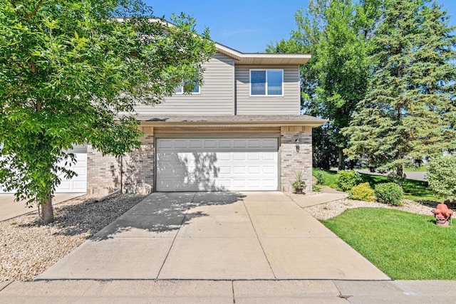 7289 32nd Ave N, Crystal, MN 55427 - view of front of house with brick siding, a garage, and concrete driveway