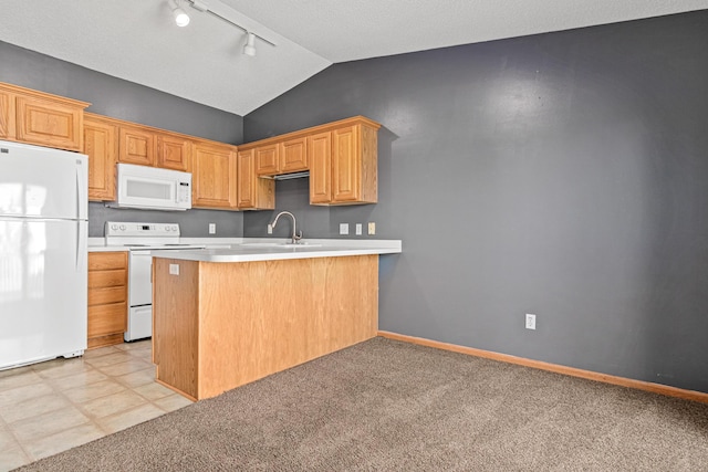 7289 32nd Ave N, Crystal, MN 55427 - kitchen featuring white appliances, rail lighting, vaulted ceiling, light countertops, and a peninsula