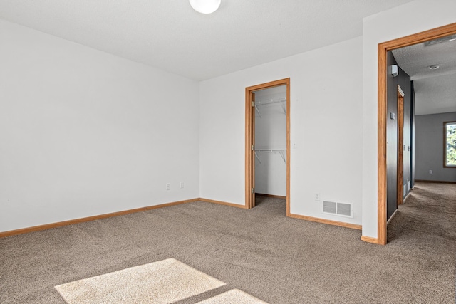 7289 32nd Ave N, Crystal, MN 55427 - unfurnished bedroom with carpet, a walk in closet, and a closet