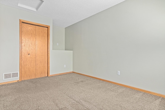 7289 32nd Ave N, Crystal, MN 55427 - unfurnished bedroom featuring carpet floors, a textured ceiling, attic access, and a closet