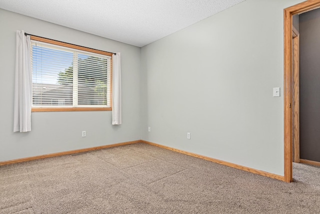 7289 32nd Ave N, Crystal, MN 55427 - carpeted spare room with baseboards and a textured ceiling