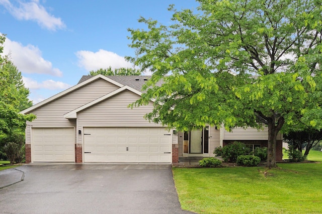 22740 Claire Ct, Rogers, MN 55374 - view of front of property with brick siding, driveway, a garage, and a front yard