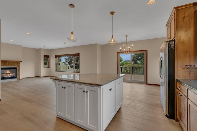 1504 20th Ave S, Sartell, MN 56377 - kitchen with plenty of natural light, light wood-type flooring, a kitchen island, dark stone countertops, and recessed lighting