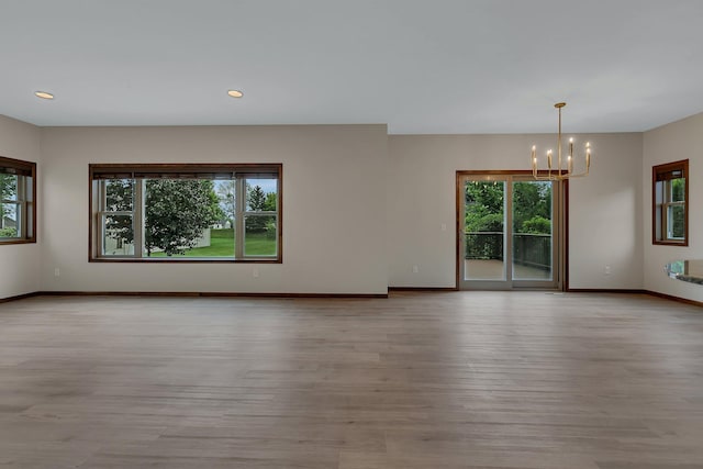 1504 20th Ave S, Sartell, MN 56377 - spare room featuring a chandelier, wood finished floors, and recessed lighting