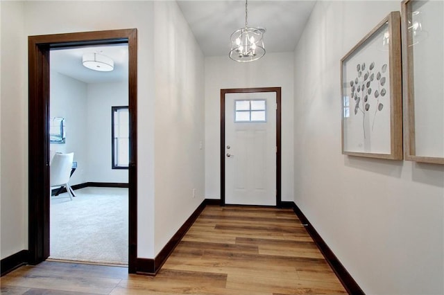 117 Maple Ct, Cannon Falls, MN 55009 - doorway to outside with a chandelier and wood finished floors