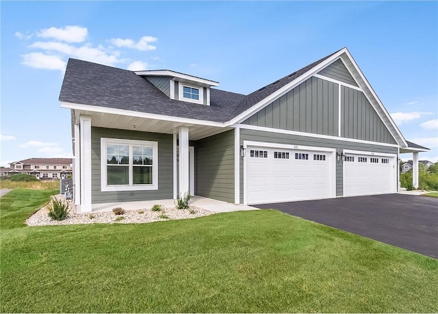 117 Maple Ct, Cannon Falls, MN 55009 - view of front of property with asphalt driveway, a front lawn, a garage, board and batten siding, and roof with shingles