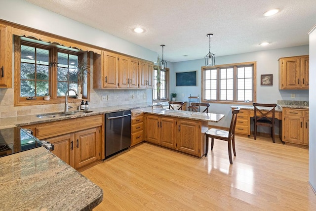 1008 3rd St NE, New Prague, MN 56071 - kitchen with dishwasher, light wood finished floors, a textured ceiling, a peninsula, and light stone counters