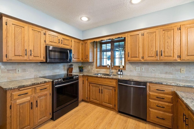 1008 3rd St NE, New Prague, MN 56071 - kitchen featuring stainless steel dishwasher, electric range, black microwave, a textured ceiling, and light wood-style flooring
