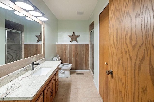 1008 3rd St NE, New Prague, MN 56071 - bathroom with wood walls, a stall shower, vanity, a wainscoted wall, and tile patterned floors