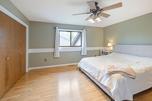 1008 3rd St NE, New Prague, MN 56071 - bedroom with light wood-style flooring, a ceiling fan, and a closet