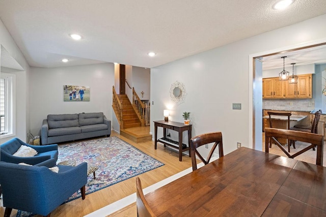 1008 3rd St NE, New Prague, MN 56071 - living room with light wood finished floors, stairway, and recessed lighting