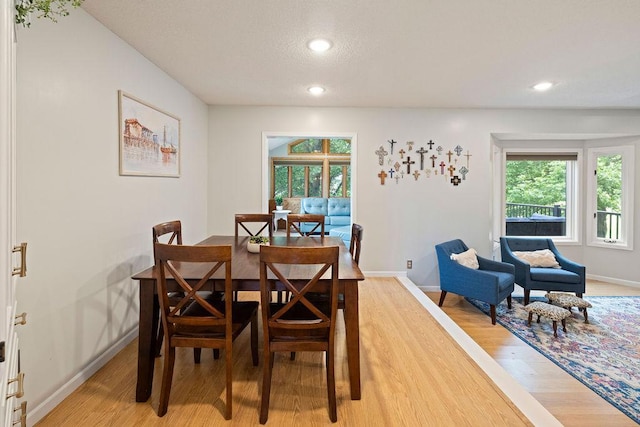 1008 3rd St NE, New Prague, MN 56071 - dining area featuring light wood-style floors, recessed lighting, and a textured ceiling