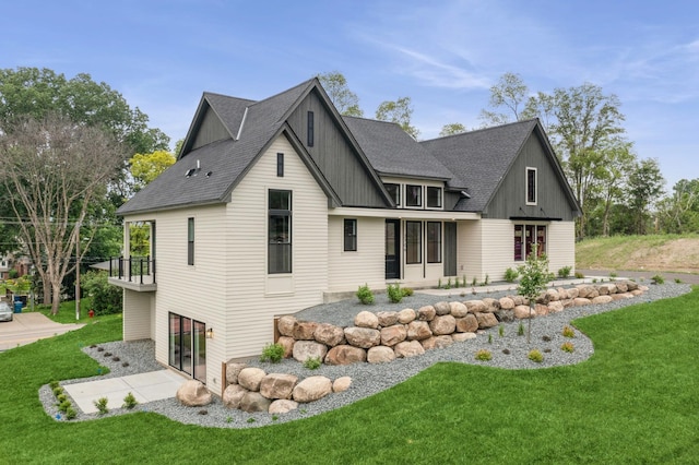 2706 Lakeview Ct, Little Canada, MN 55117 - back of house with a lawn, board and batten siding, a patio area, and a shingled roof