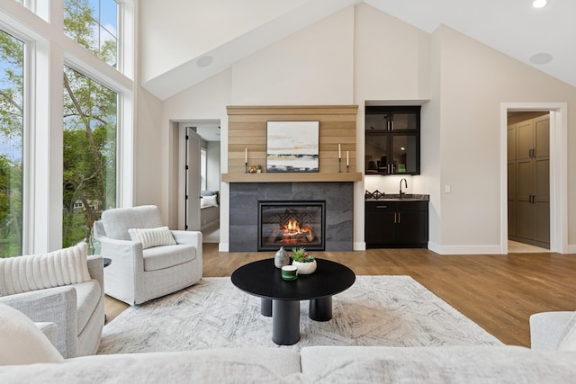 2706 Lakeview Ct, Little Canada, MN 55117 - living area featuring high vaulted ceiling, a tiled fireplace, wood finished floors, and recessed lighting