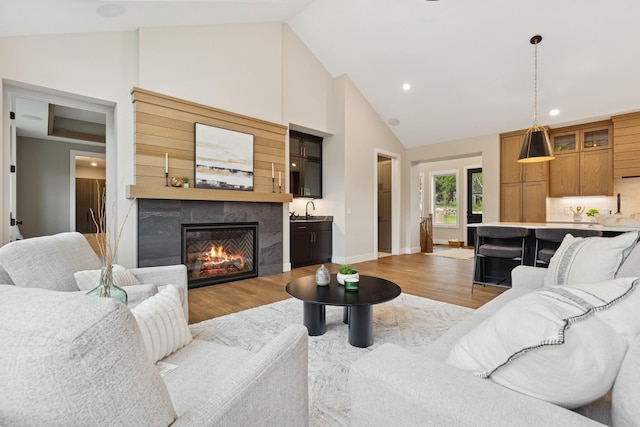 2706 Lakeview Ct, Little Canada, MN 55117 - living area featuring light wood-type flooring, a high end fireplace, recessed lighting, and high vaulted ceiling