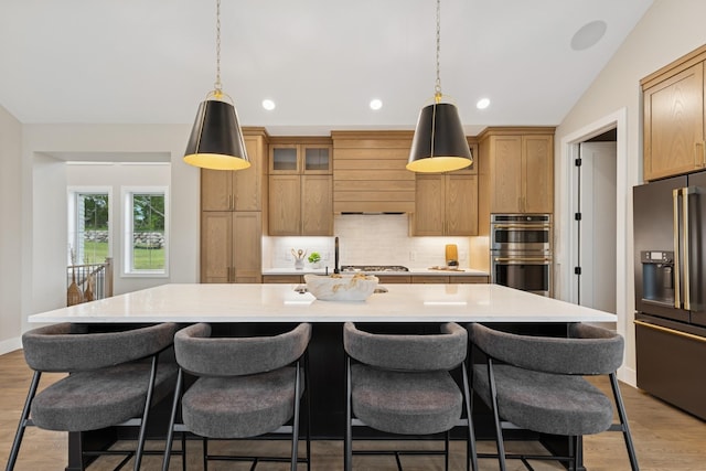 2706 Lakeview Ct, Little Canada, MN 55117 - kitchen featuring stainless steel appliances, backsplash, light countertops, a kitchen island with sink, and decorative light fixtures