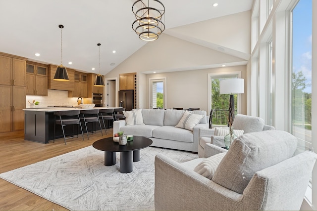 2706 Lakeview Ct, Little Canada, MN 55117 - living room featuring high vaulted ceiling, recessed lighting, and light wood-style flooring