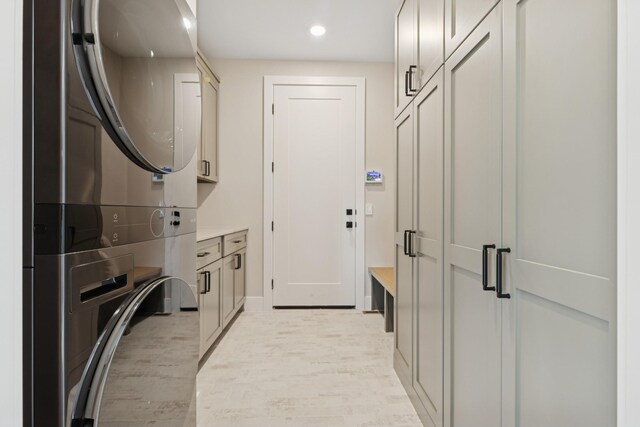 2706 Lakeview Ct, Little Canada, MN 55117 - washroom featuring cabinet space, stacked washer and clothes dryer, light wood-style floors, and recessed lighting