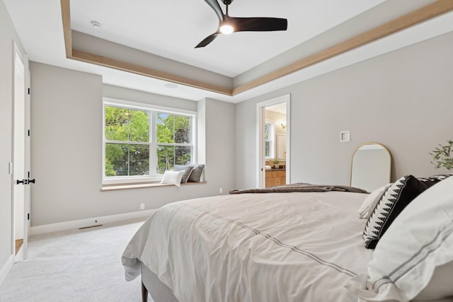 2706 Lakeview Ct, Little Canada, MN 55117 - bedroom with a tray ceiling, light carpet, ensuite bath, and ceiling fan
