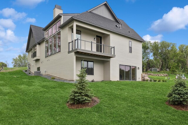 2706 Lakeview Ct, Little Canada, MN 55117 - rear view of property featuring a balcony, a chimney, a lawn, and roof with shingles