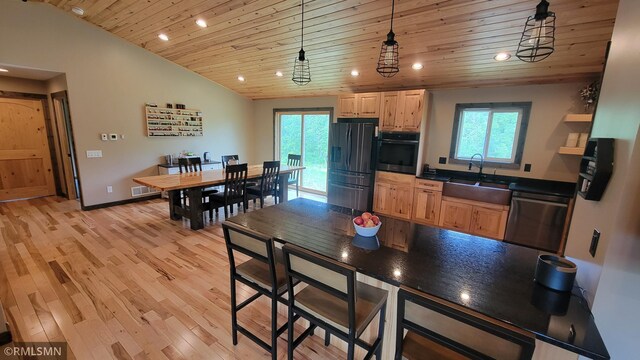 1912 Nelson Lake Rd, Pillager, MN 56473 - kitchen with refrigerator with ice dispenser, wood ceiling, stainless steel dishwasher, black oven, and recessed lighting