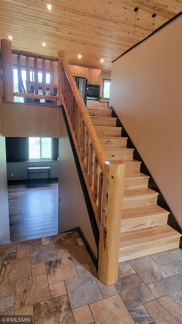 1912 Nelson Lake Rd, Pillager, MN 56473 - staircase featuring stone tile flooring, wooden ceiling, and recessed lighting