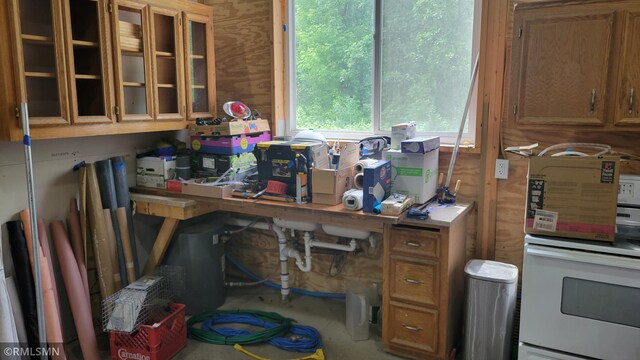 1912 Nelson Lake Rd, Pillager, MN 56473 - kitchen with brown cabinets, range, and glass insert cabinets