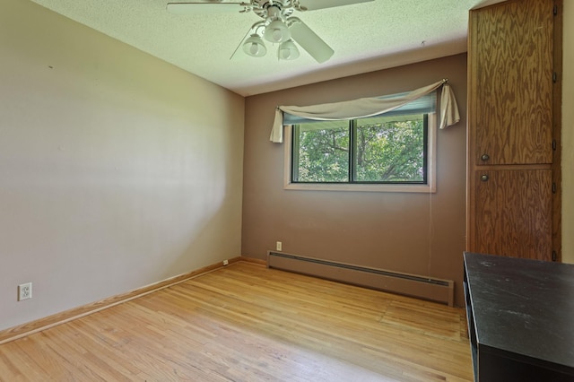 39743 County Road 1, Brockway Twp, MN 56367 - unfurnished room featuring a baseboard radiator, light wood-type flooring, ceiling fan, and a textured ceiling
