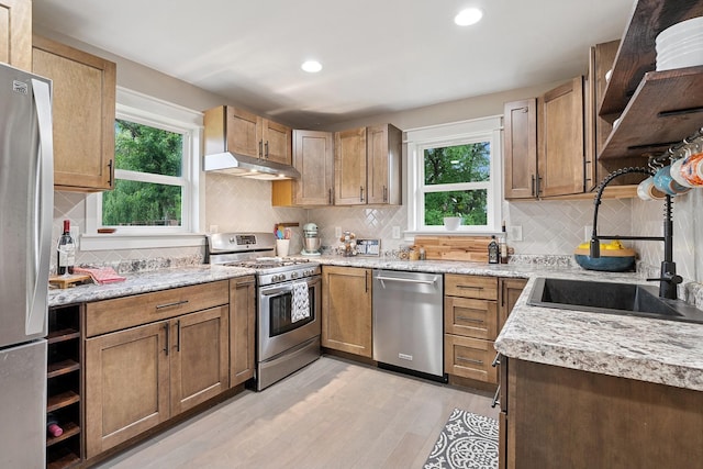 3178 253rd Ave NW, Isanti, MN 55040 - kitchen with stainless steel appliances, under cabinet range hood, light wood finished floors, healthy amount of natural light, and recessed lighting